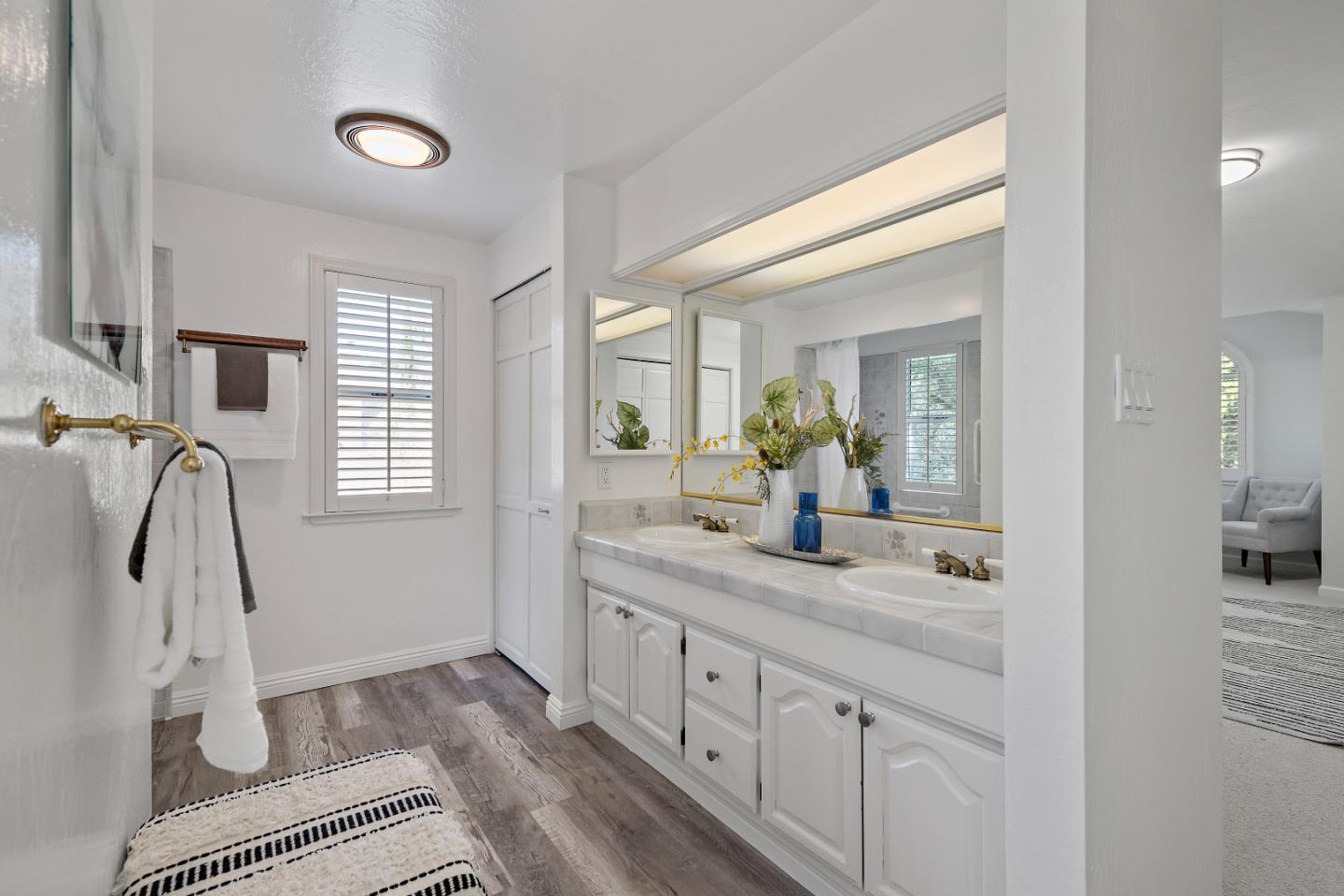 360 Iris Way Palo Alto, CA 94303 - Photo 23 of 28 a bathroom with a granite countertop sink and a mirror