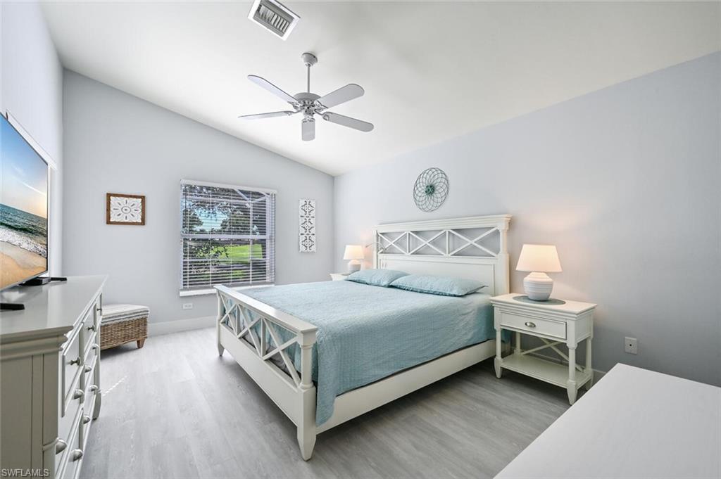 8449 Indian Wells Way Naples, FL 34113 - Photo 13 of 35 a bedroom with a bed and a window