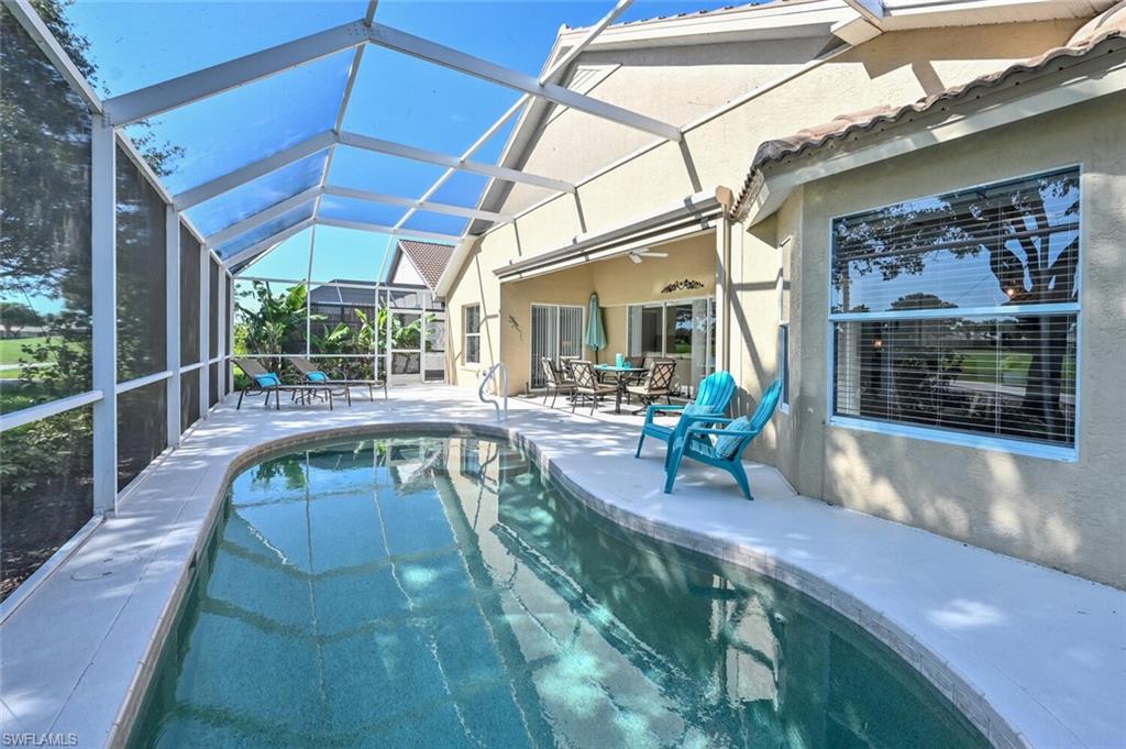 8449 Indian Wells Way Naples, FL 34113 - Photo 22 of 35 a view of a swimming pool with outdoor seating