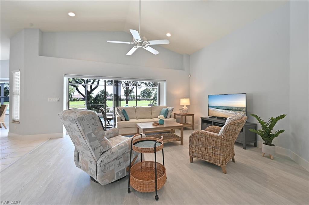 8449 Indian Wells Way Naples, FL 34113 - Photo 7 of 35 a living room with furniture and a large window