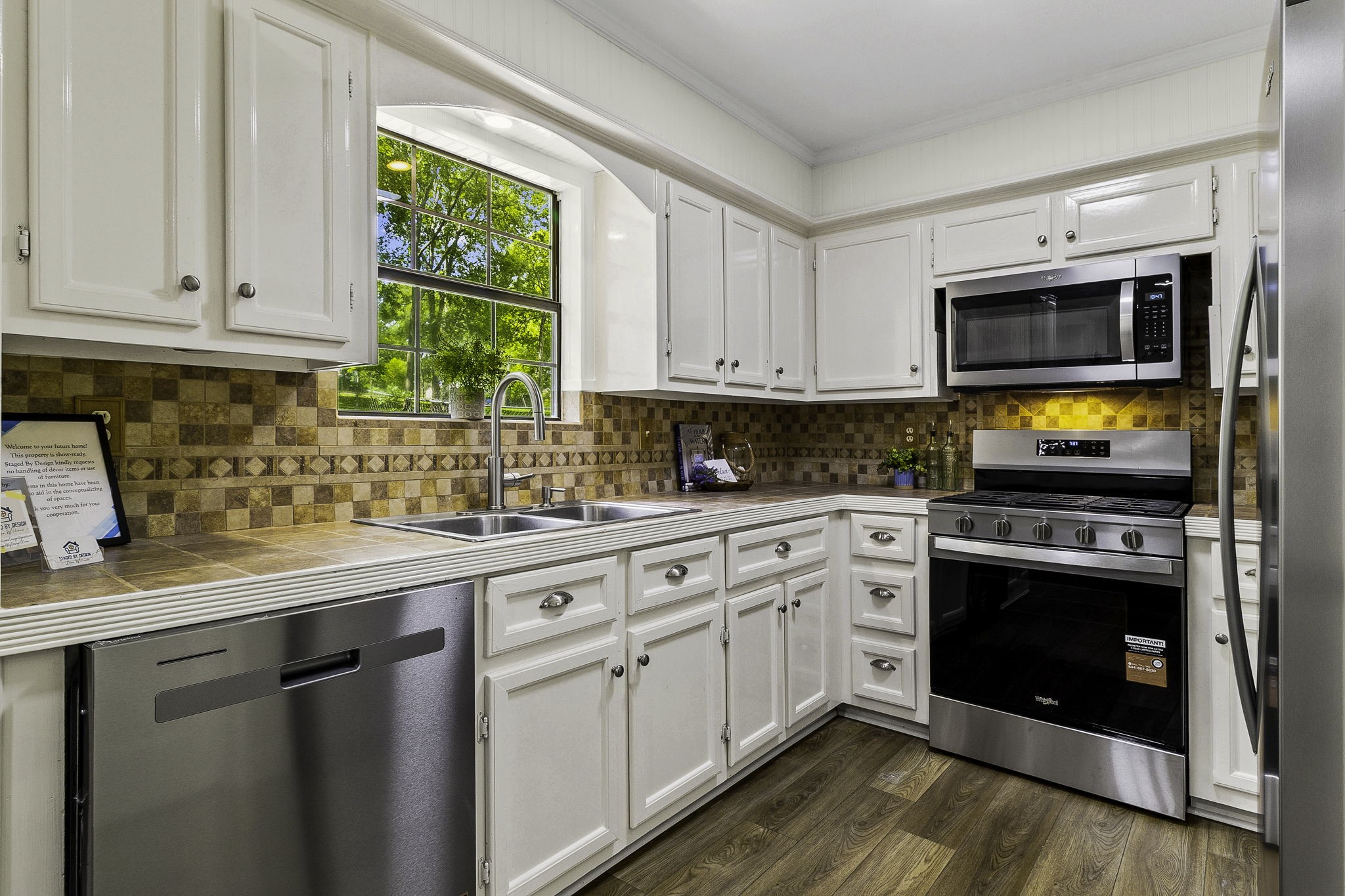 51 Rustling Oaks Coldspring, TX 77331 - Photo 16 of 43 Brand new kitchen appliances. Lovely view of the back yard, and lot behind it (Lot 4)