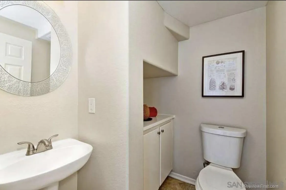 1845 Monaco Drive Chula Vista, CA 91913 - Photo 2 of 10 a bathroom with a toilet a sink and mirror