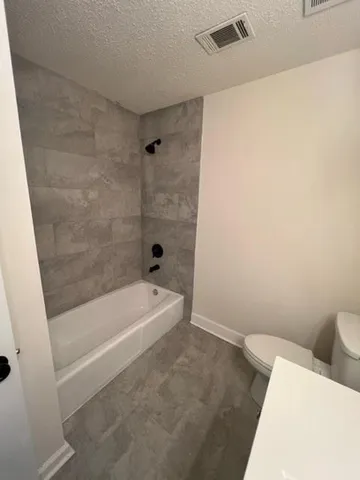 a bathroom with a bathtub and a toilet