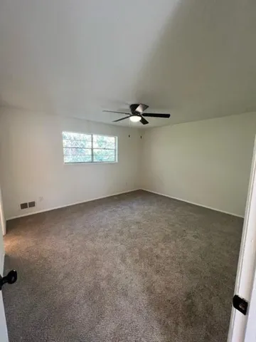 an empty room with a empty space and windows