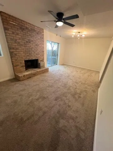 a view of empty room with window and fireplace