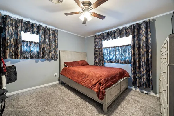 a bed sitting in a bedroom next to a window