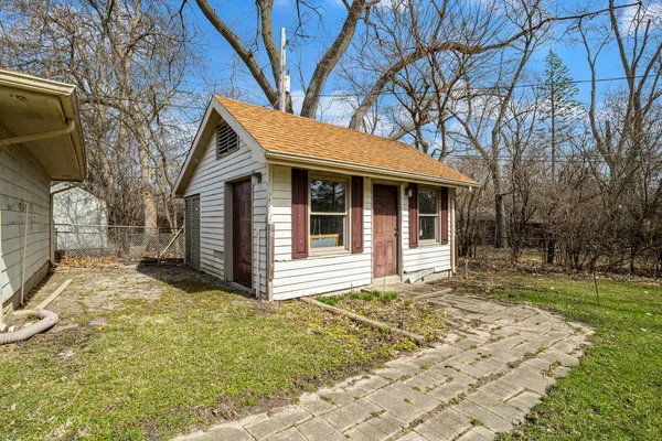 a view of a house with a yard covered in snow