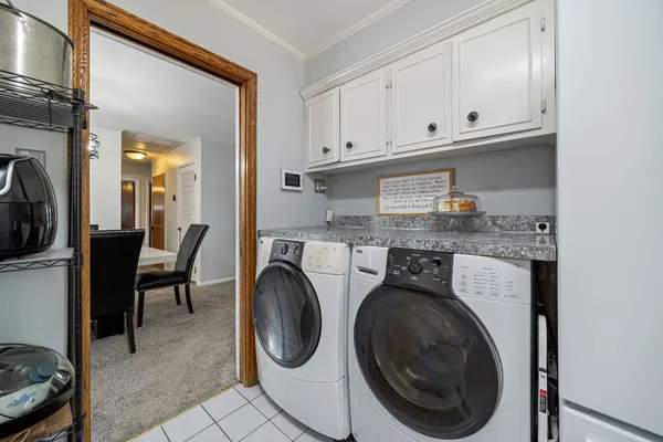 a utility room with sink dryer and washer