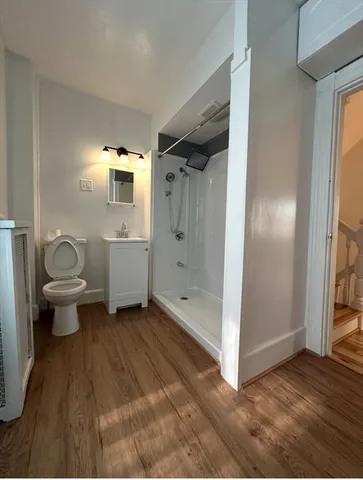 a bathroom with a toilet sink and shower