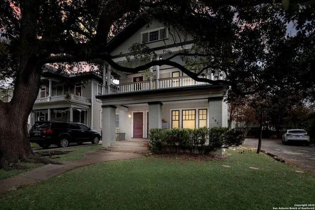 a view of a house with a large window and a yard
