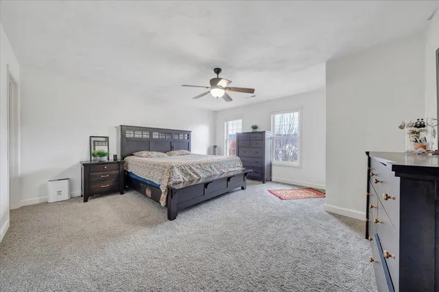 a bathroom with a tub a sink and a large mirror