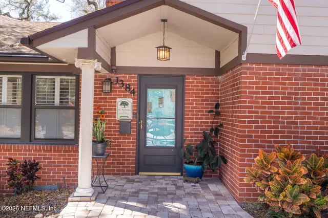 a kitchen with a refrigerator a stove and a sink with wooden floor