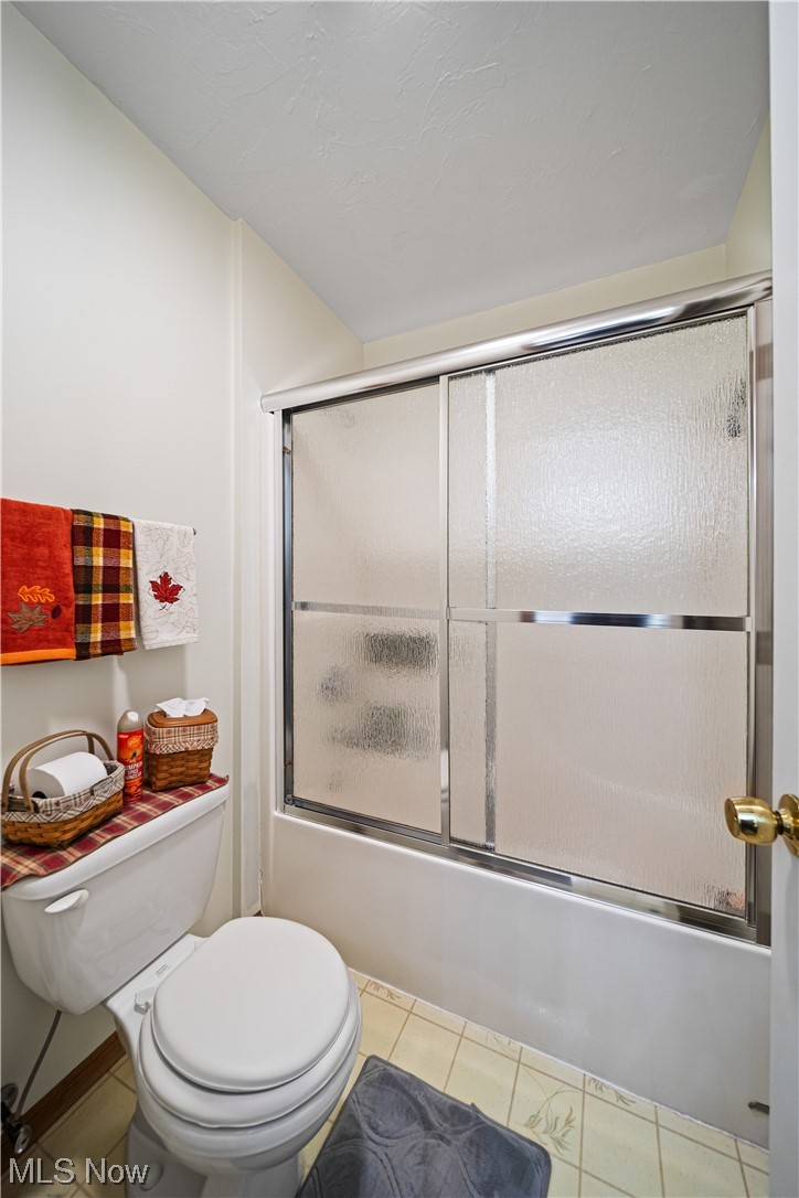 431 Ansel Road Geneva, OH 44041 - Photo 35 of 35 Bathroom with bath / shower combo with glass door and light tile flooring
