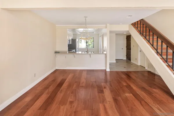 a view of a room with wooden floor and staircase