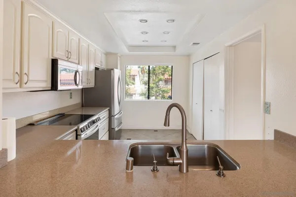 a kitchen with cabinets and steel stainless steel appliances