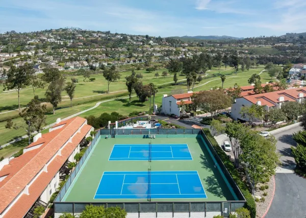 an aerial view of a house with swimming pool and outdoor seating
