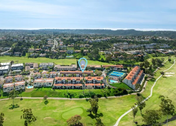 an aerial view of residential houses with outdoor space and swimming pool