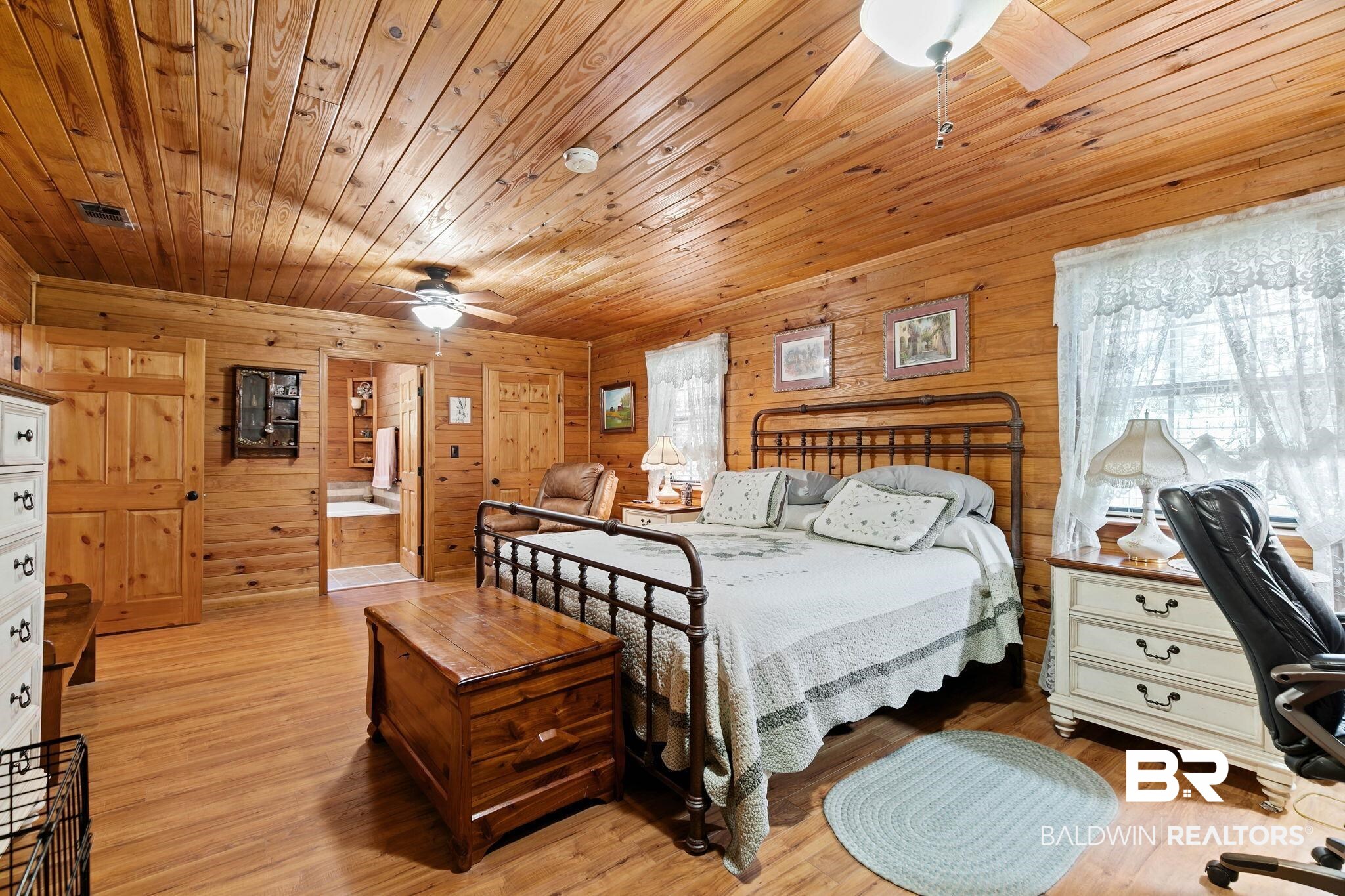 724 Rowell Lane Brewton, AL 36426 - Photo 19 of 40 Bedroom with wooden ceiling, light wood-style floors, wooden walls, and an office area