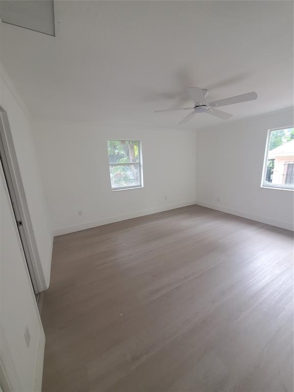 74 Northwest 31st Street, Unit 1 Miami, FL 33127 - Photo 4 of 14 an empty room with a empty space and windows