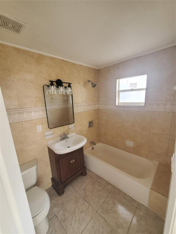 74 Northwest 31st Street, Unit 1 Miami, FL 33127 - Photo 5 of 14 a bathroom with a bathtub sink and toilet