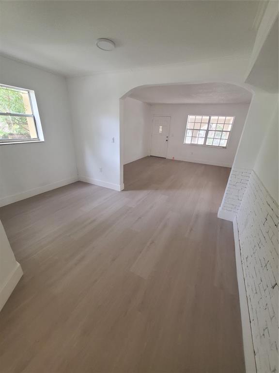 74 Northwest 31st Street, Unit 1 Miami, FL 33127 - Photo 7 of 14 an empty room with windows