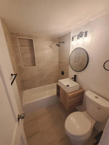 a bathroom with a toilet a sink and bathtub