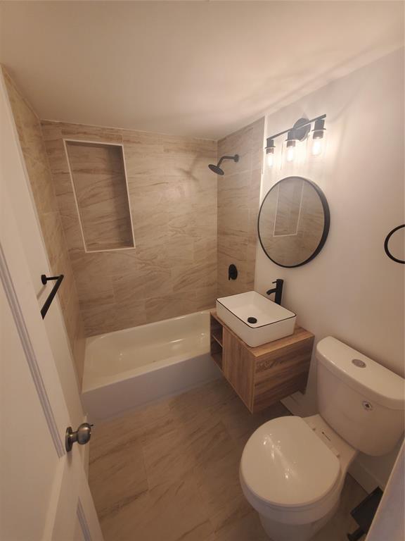 74 Northwest 31st Street, Unit 1 Miami, FL 33127 - Photo 9 of 14 a bathroom with a toilet a sink and bathtub