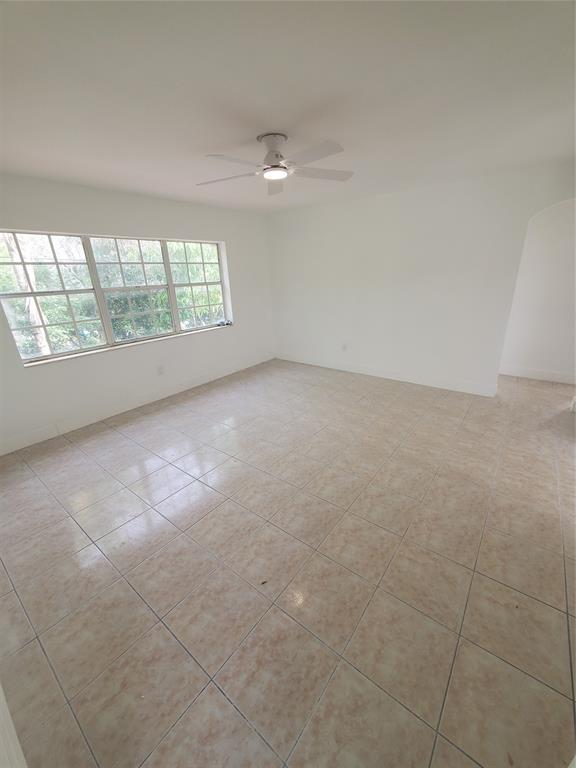 74 Northwest 31st Street, Unit 1 Miami, FL 33127 - Photo 10 of 14 an empty room with windows and city view
