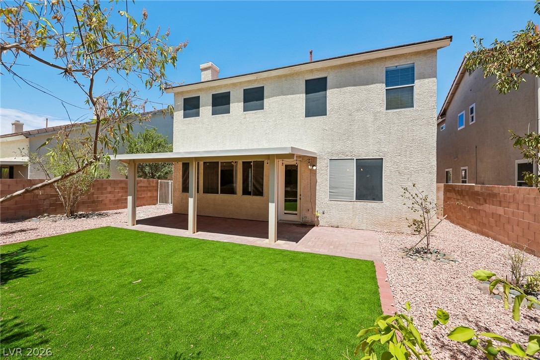 1727 Millstream Way Henderson, NV 89074 - Photo 44 of 46 A private backyard oasis features a covered patio perfect for entertaining and low-maintenance landscaping.