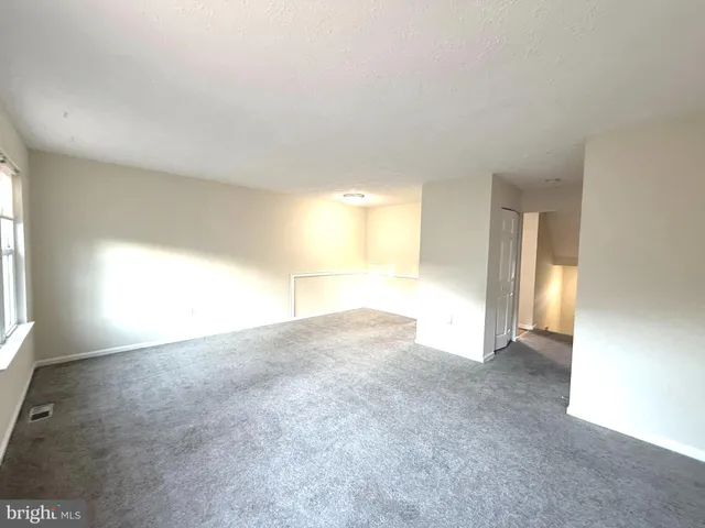 a kitchen with granite countertop a sink cabinets and stainless steel appliances
