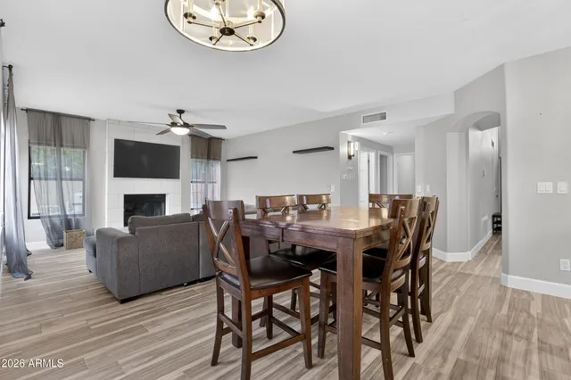 a living room with furniture and a large window with wooden floor