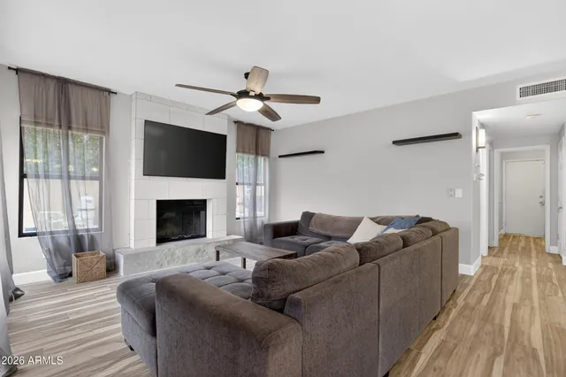 a living room with furniture and a ceiling fan
