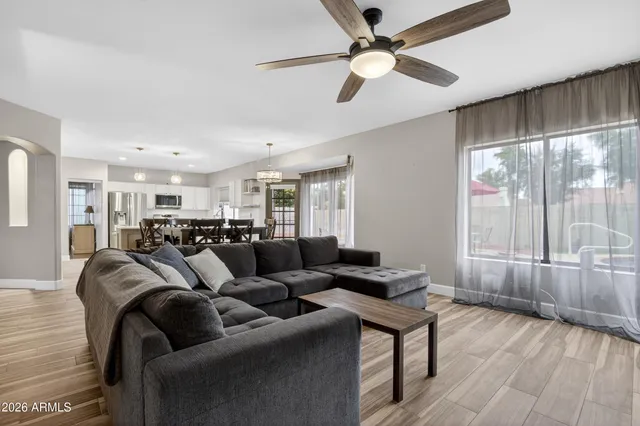 a view of a livingroom with wooden floor and furniture