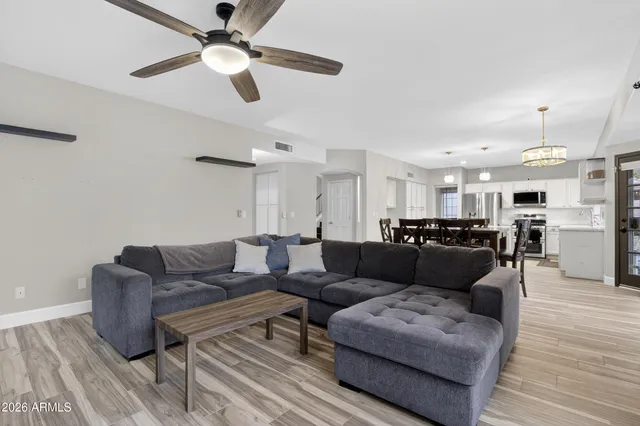 a view of living room with furniture and a fireplace