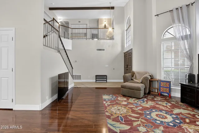 a bedroom with a bed and large windows