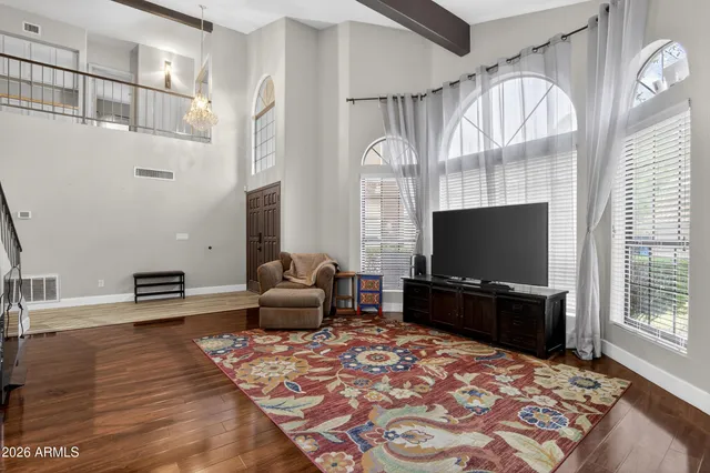 a bedroom with a large bed and a chandelier