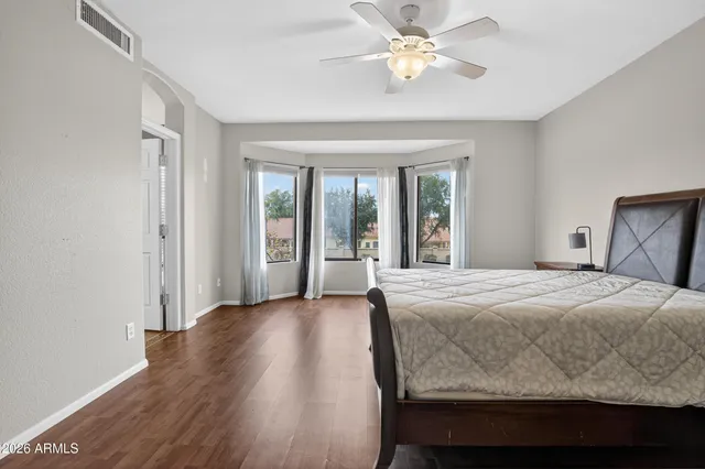 a bathroom with double vanity sinks a vanity a lamp and a mirror