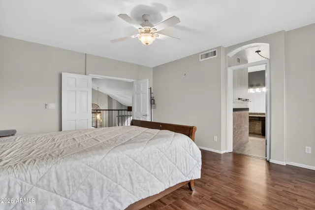 a bathroom with a granite countertop double vanity sink and a mirror