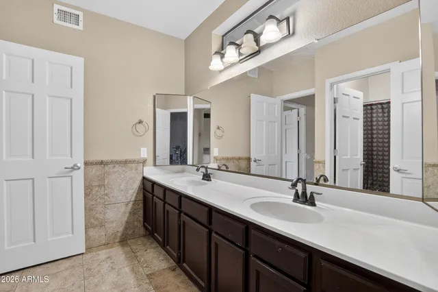 an empty room with wooden floor cabinet and ceiling fan