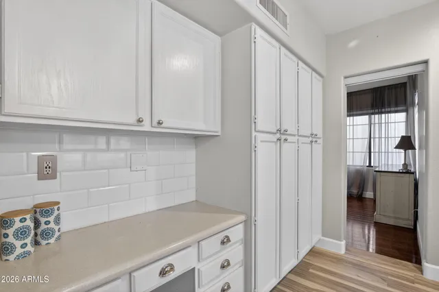 a kitchen with stainless steel appliances white cabinets a stove and a microwave