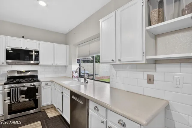 a view of a a dining room with furniture window and wooden floor