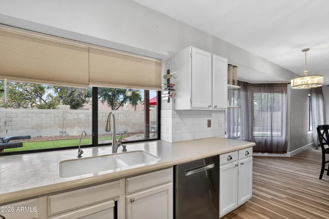 a view of a dining room with furniture wooden floor and chandelier