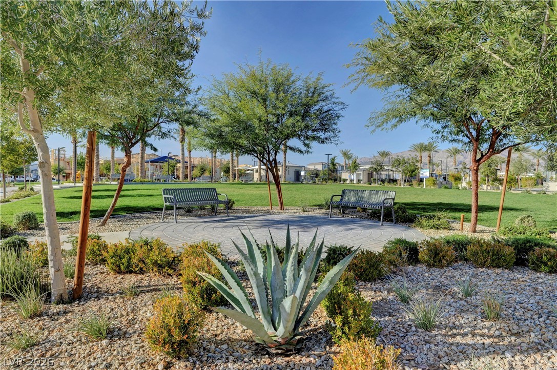6924 Spicy Merlot Street North Las Vegas, NV 89086 - Photo 74 of 83 A tranquil green space with benches offers a serene spot for relaxation and community gatherings.