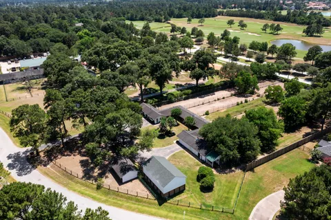 an aerial view of a house with a yard and lake view