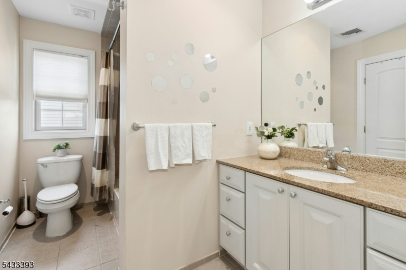 33 Stanton Street Clark, NJ 07066 - Photo 30 of 37 a bathroom with a granite countertop sink a toilet and a mirror