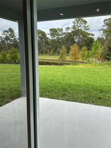 a bedroom with a bed and painting on the wall