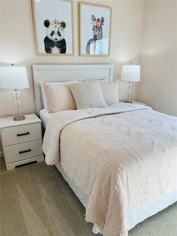 a bedroom with a bed and a dresser