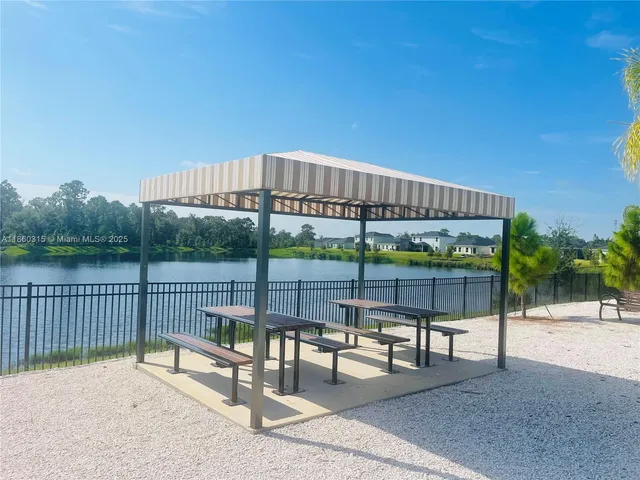 a view of a patio with a table and chairs under an umbrella