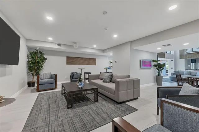 an aerial view of a house with a yard and lake view in back