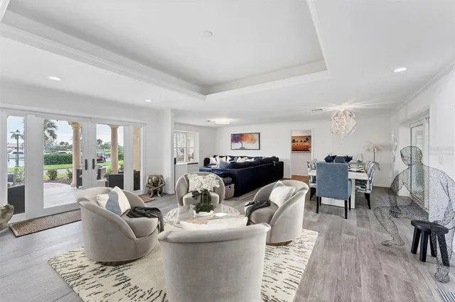 a living room with furniture a large window and a dining table